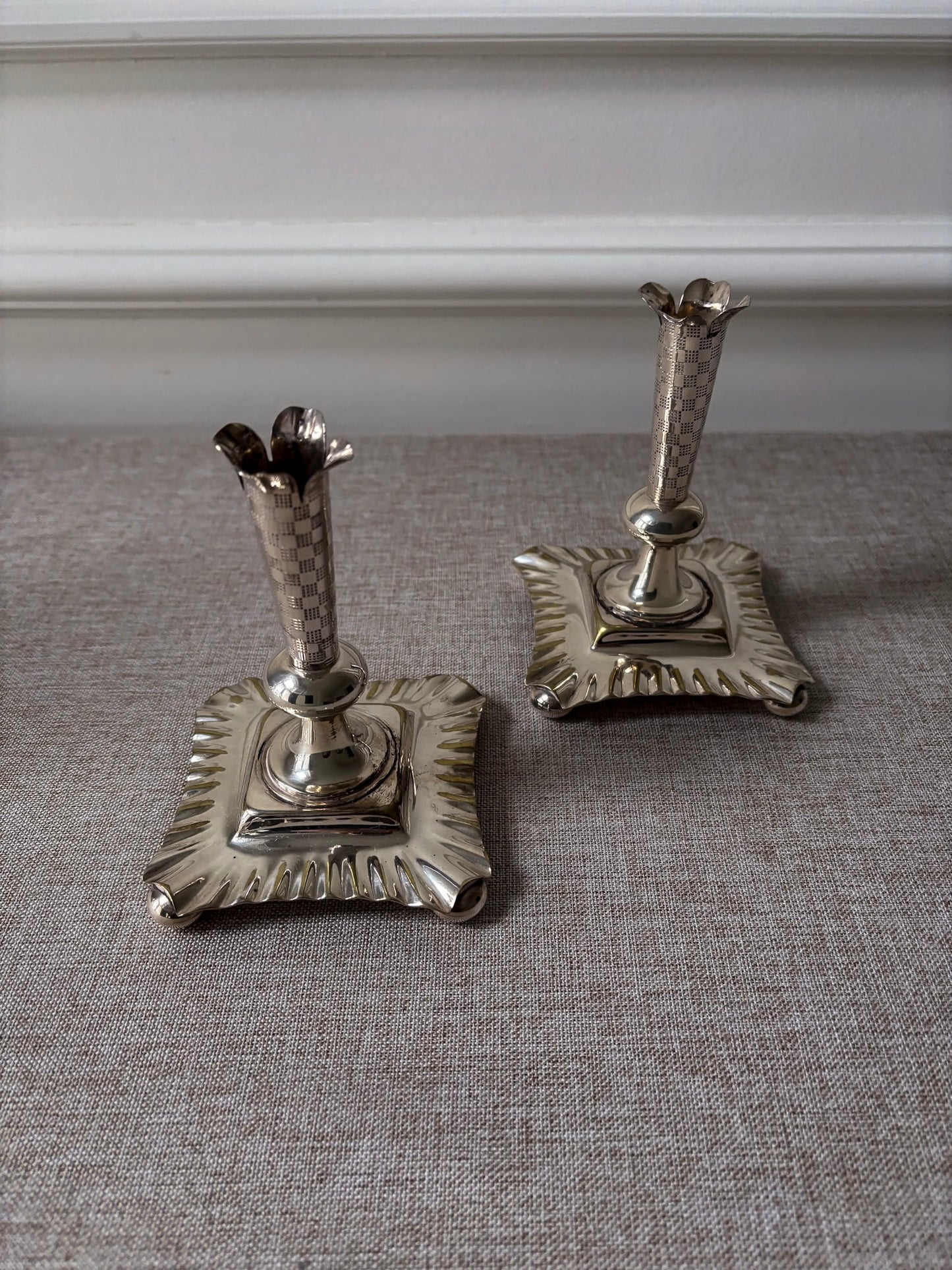 A Pair of Silver-Plated Chequered Candlesticks