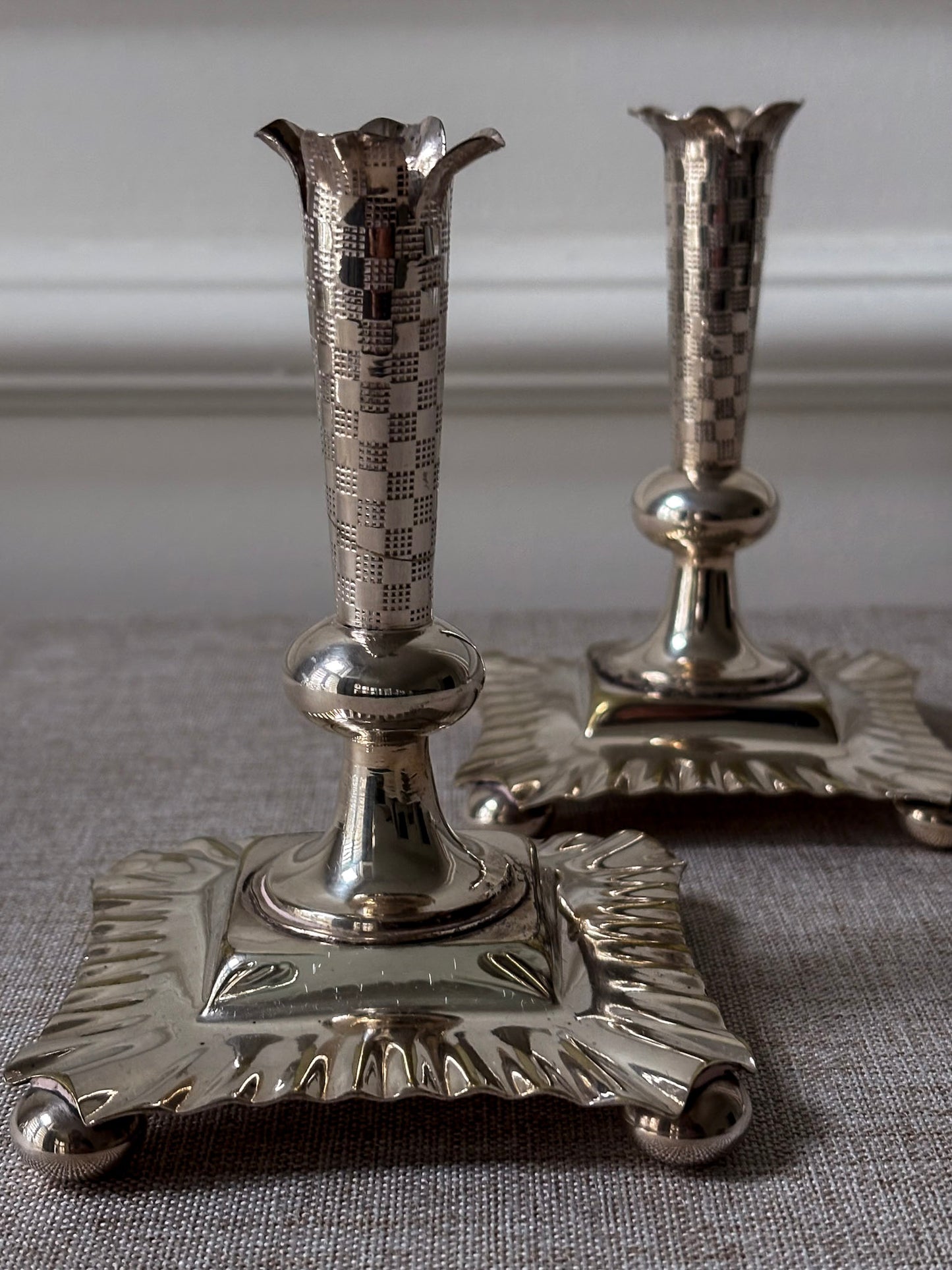 A Pair of Silver-Plated Chequered Candlesticks