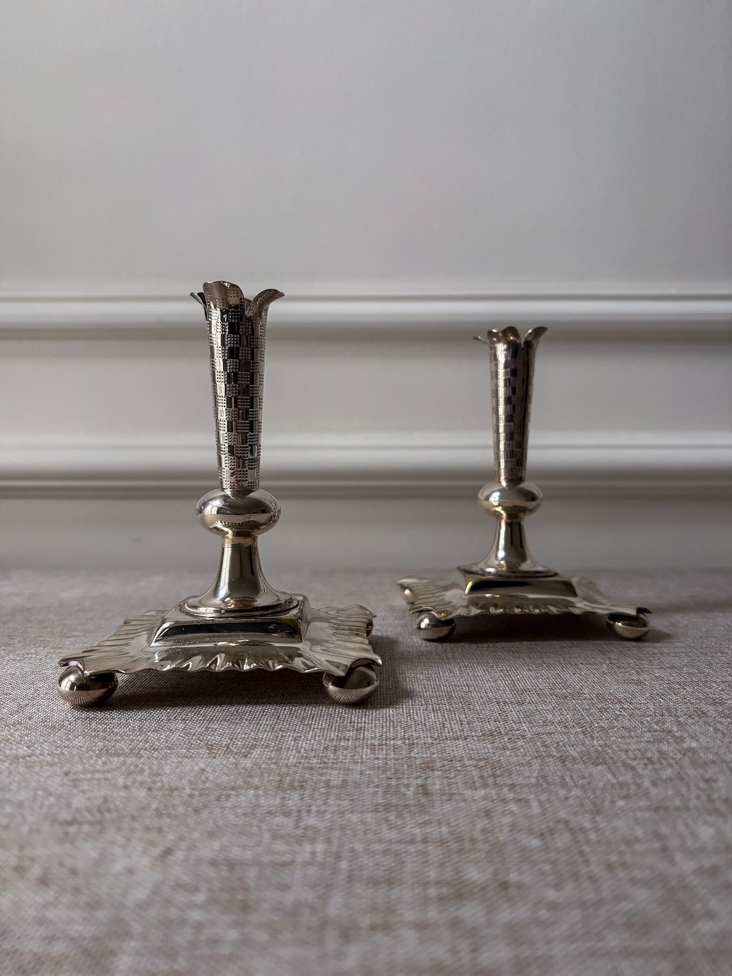 A Pair of Silver-Plated Chequered Candlesticks